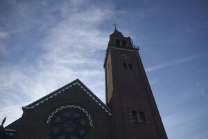 Historic church tower under a blue sky in Noord-Brabant, Nederla