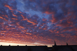 Spectaculaire zonsondergang boven dakeinden